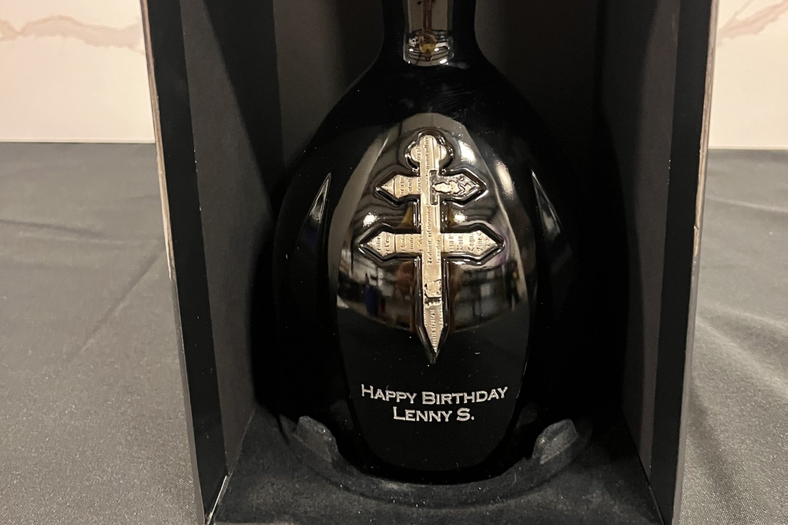 Engraved D'Usse cognac bottle with a personalized birthday message in a black gift box