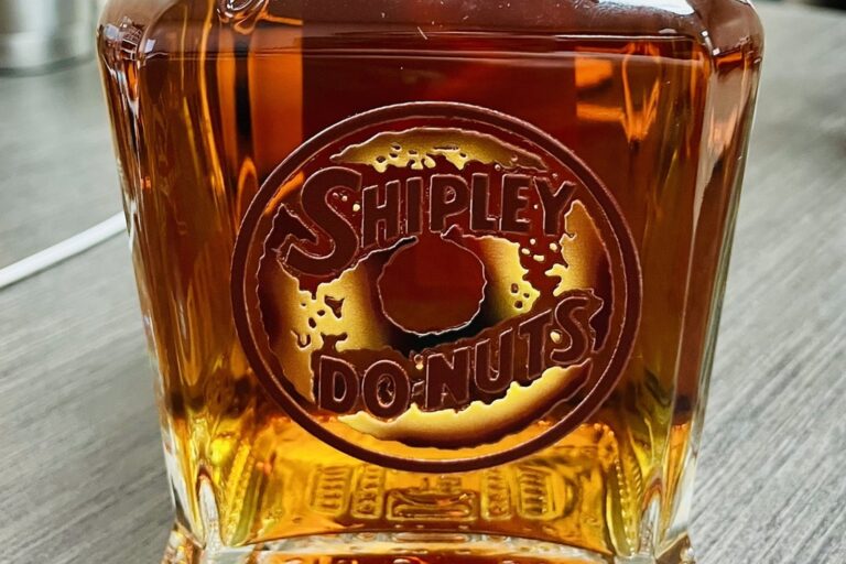 Full-color UV printed Shipley Do-Nuts label on a whiskey bottle by etchXpress